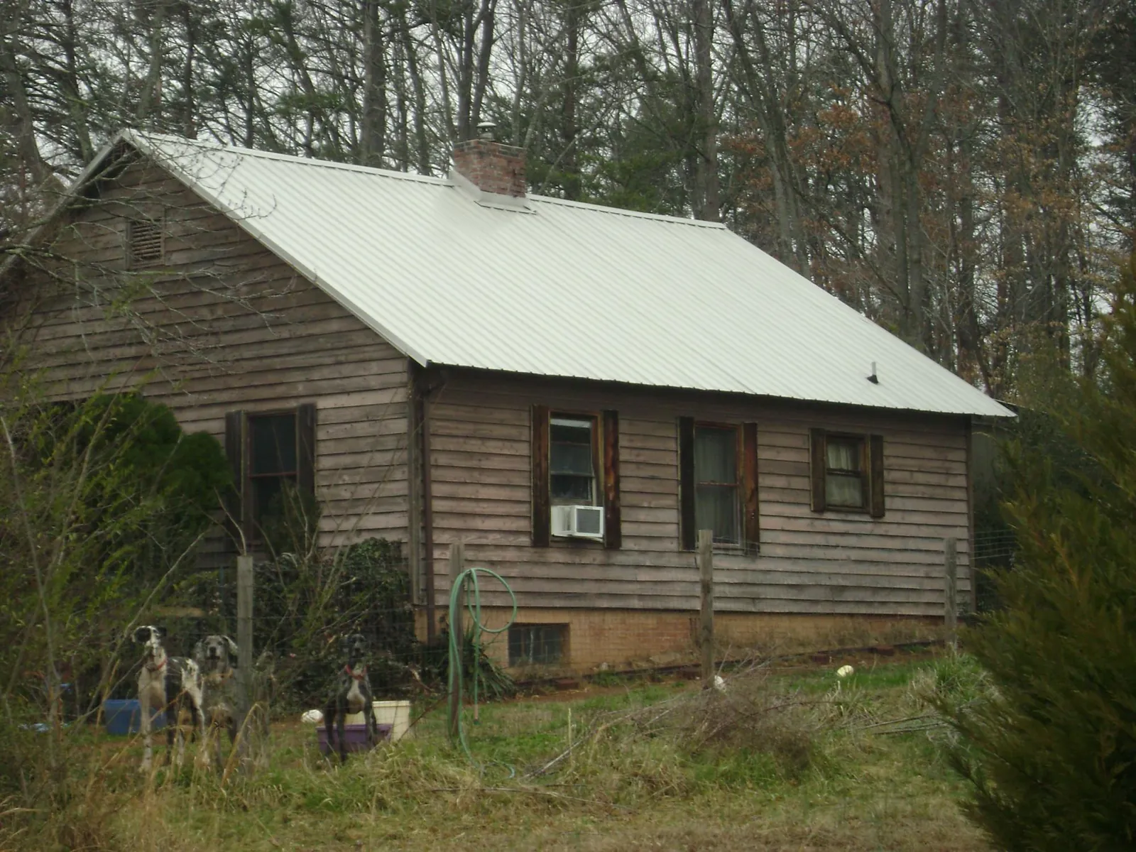 White metal roof on an old wood sided farmhouse, from a Metal Roof Installation job in Sandersville